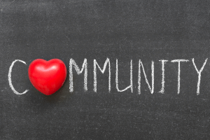 Community on chalkboard with red heart for letter O