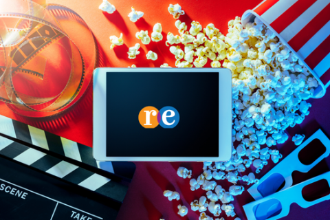 Movie clipboard with popcorn and 3D glasses and small digital device with RE logo in center